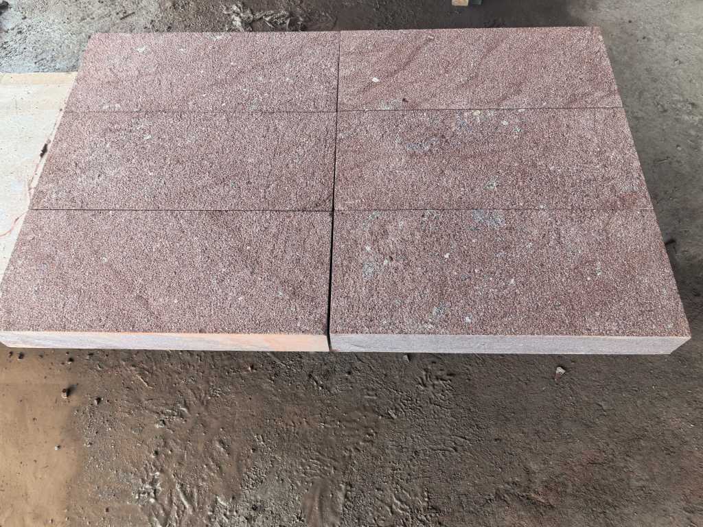 Bush-hammered Dayang Red granite showing a regular pitted texture for exterior paving.