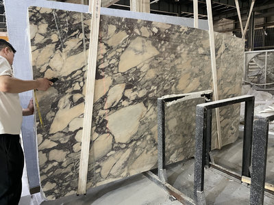 Quality inspection of finished Calacatta Viola marble slabs