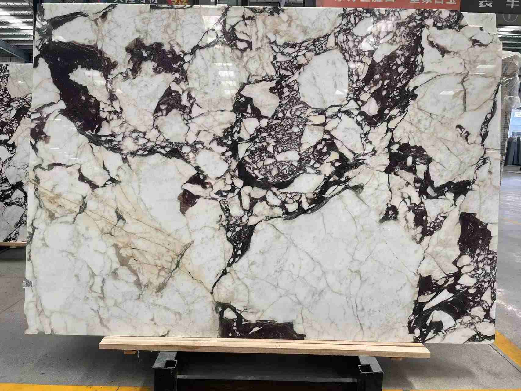 Calacatta Viola marble slab with a creamy white background and burgundy-violet veining