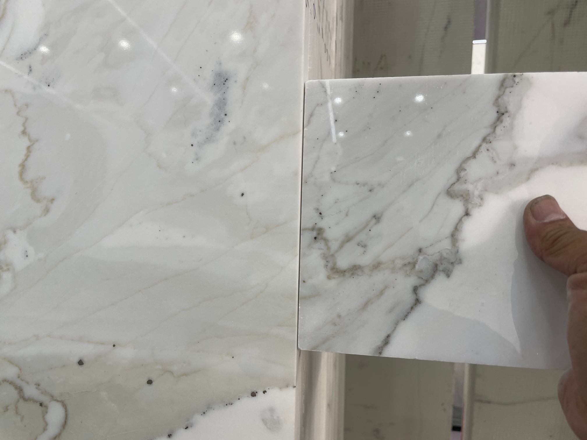 Calacatta White Sample and Slab Matching Customer Calacatta White sample matched to slab with side grey veining