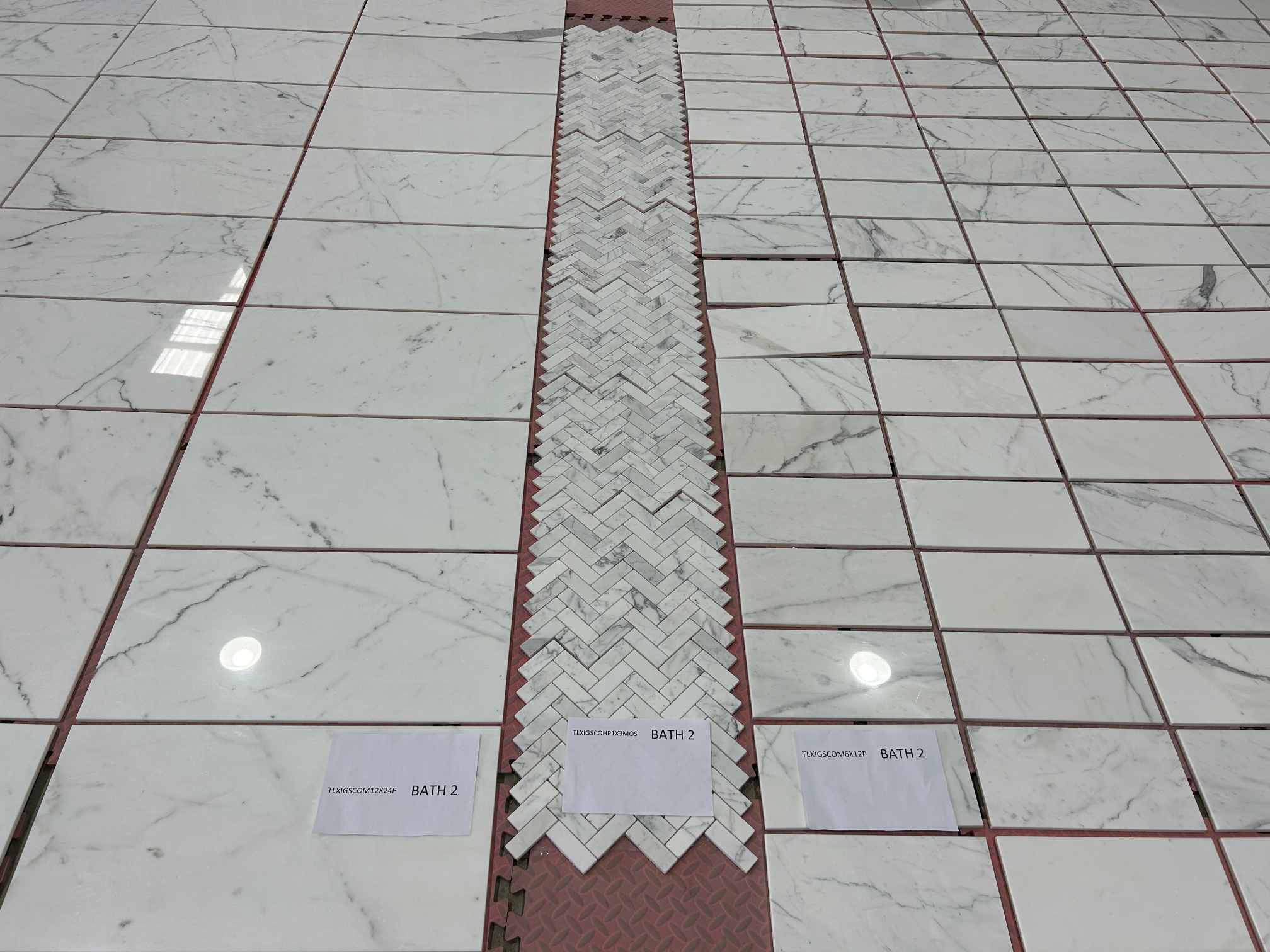 Calacatta White Herringbone and Custom Tiles Calacatta White herringbone mosaic with custom cut-to-size marble tiles