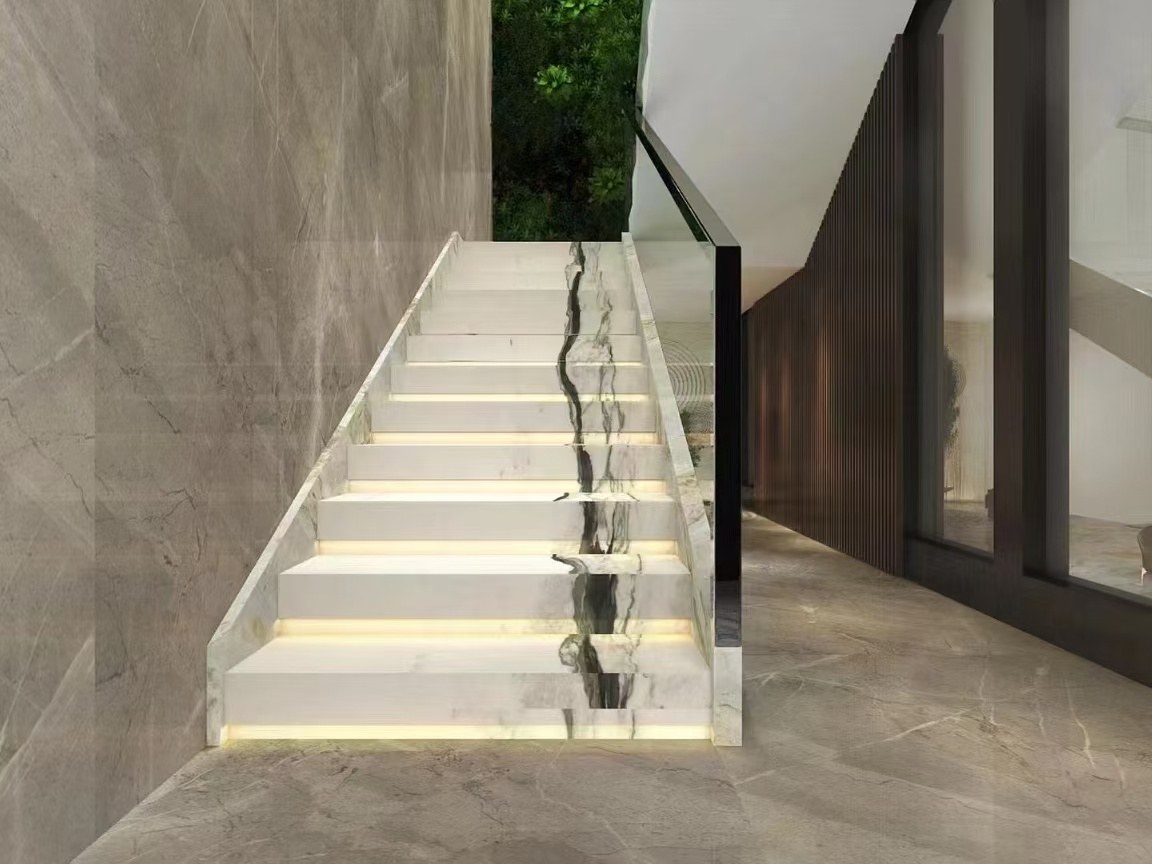 Oriental Calacatta White marble stair treads with bold black veins continuing across successive steps