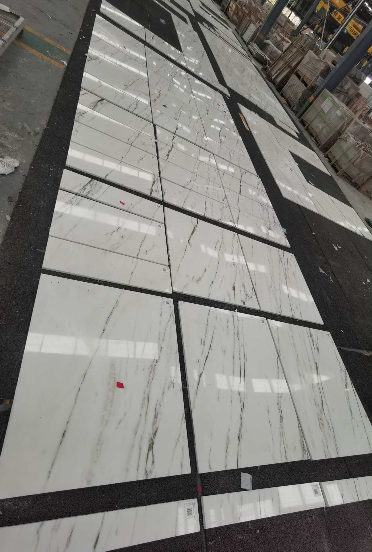 Oriental Calacatta White tiles pre-laid with stronger black veining and continuous movement