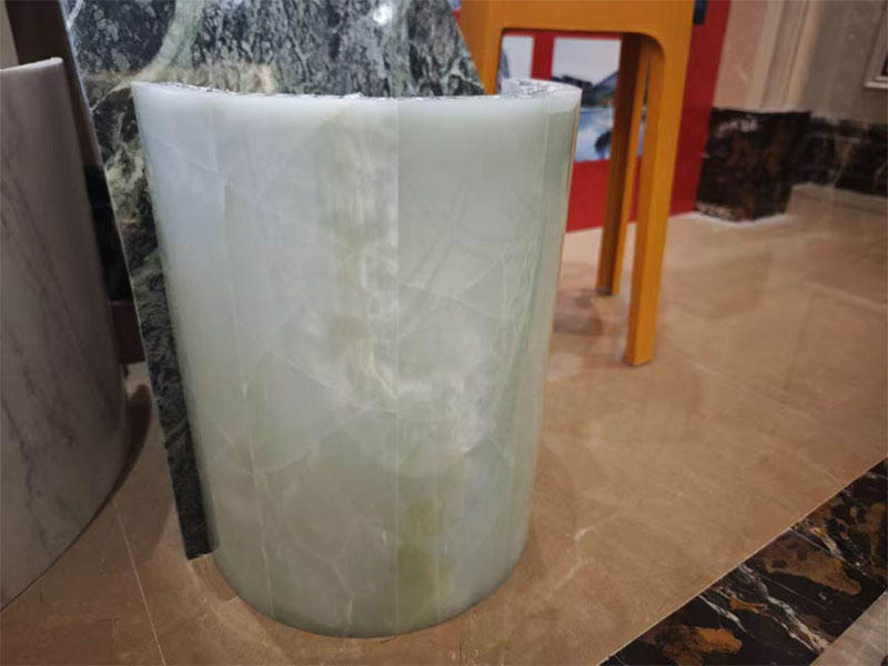 Curved marble facing with its supporting backing during fabrication.